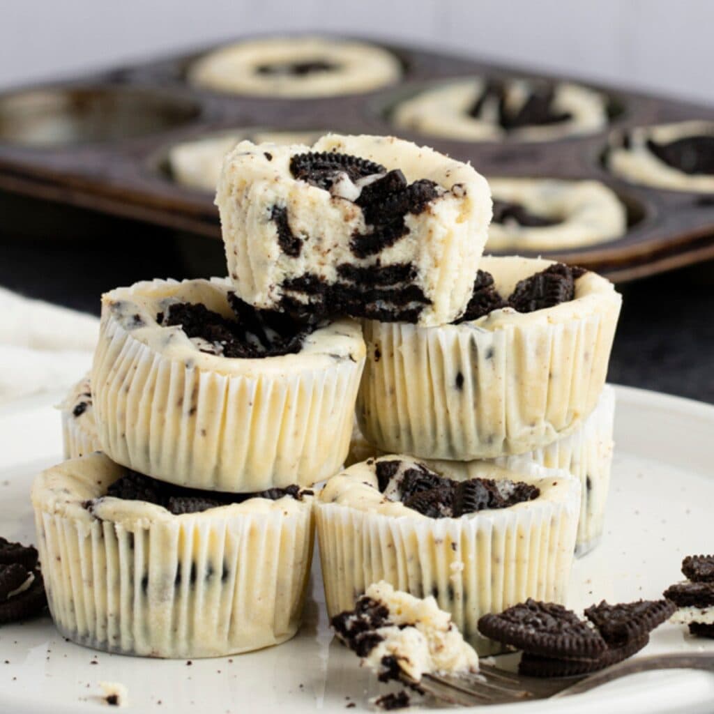 Stack of Oreo cheesecake bites on a plate.