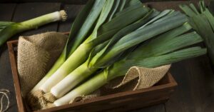 Raw Organic Green Leeks on a Wooden Crate