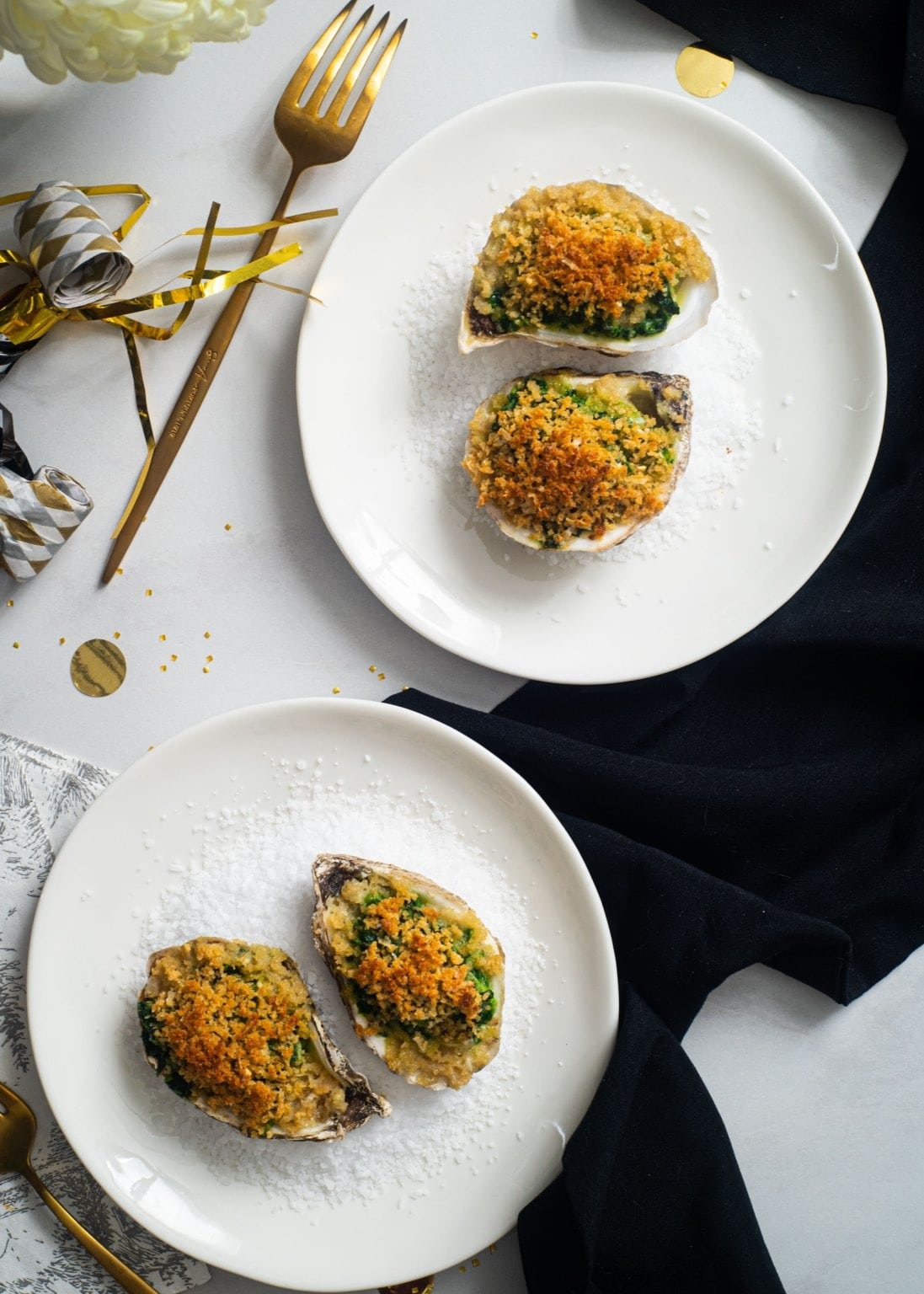 Servings for two baked oyster stuffed with spinach and crumbly toppings. 
