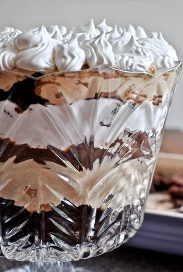 Peanut butter fudge brownie trifle with layers of brownies and cream cheese topped with whipped cream. 