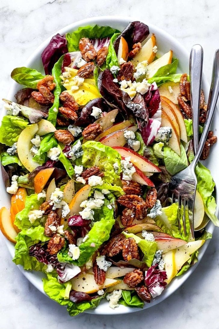 Green salad topped with crunchy pears, creamy gorgonzola cheese, and candied pecans drizzled with a Dijon vinaigrette dressing.
