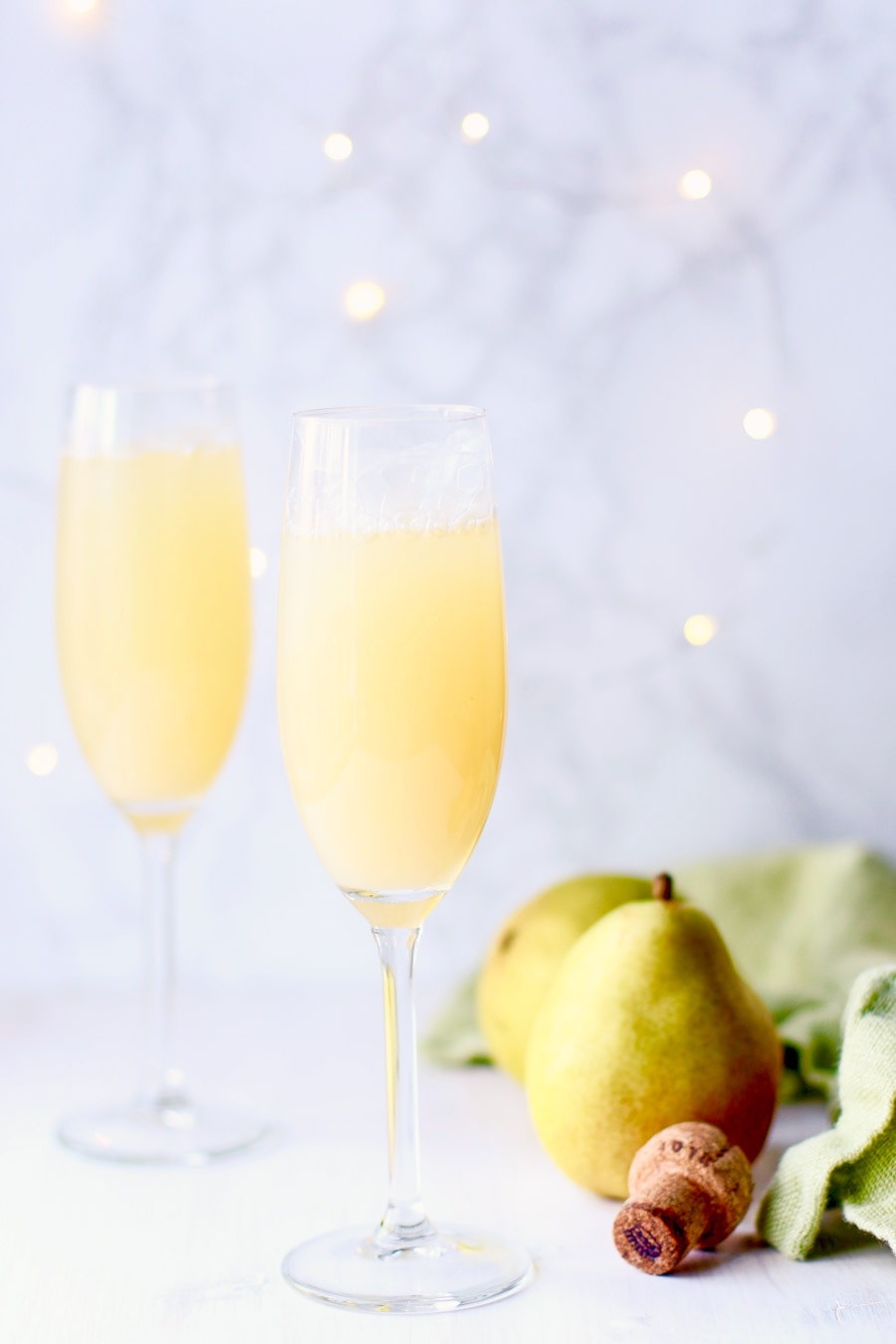 Pear prosecco punch served in wine glasses