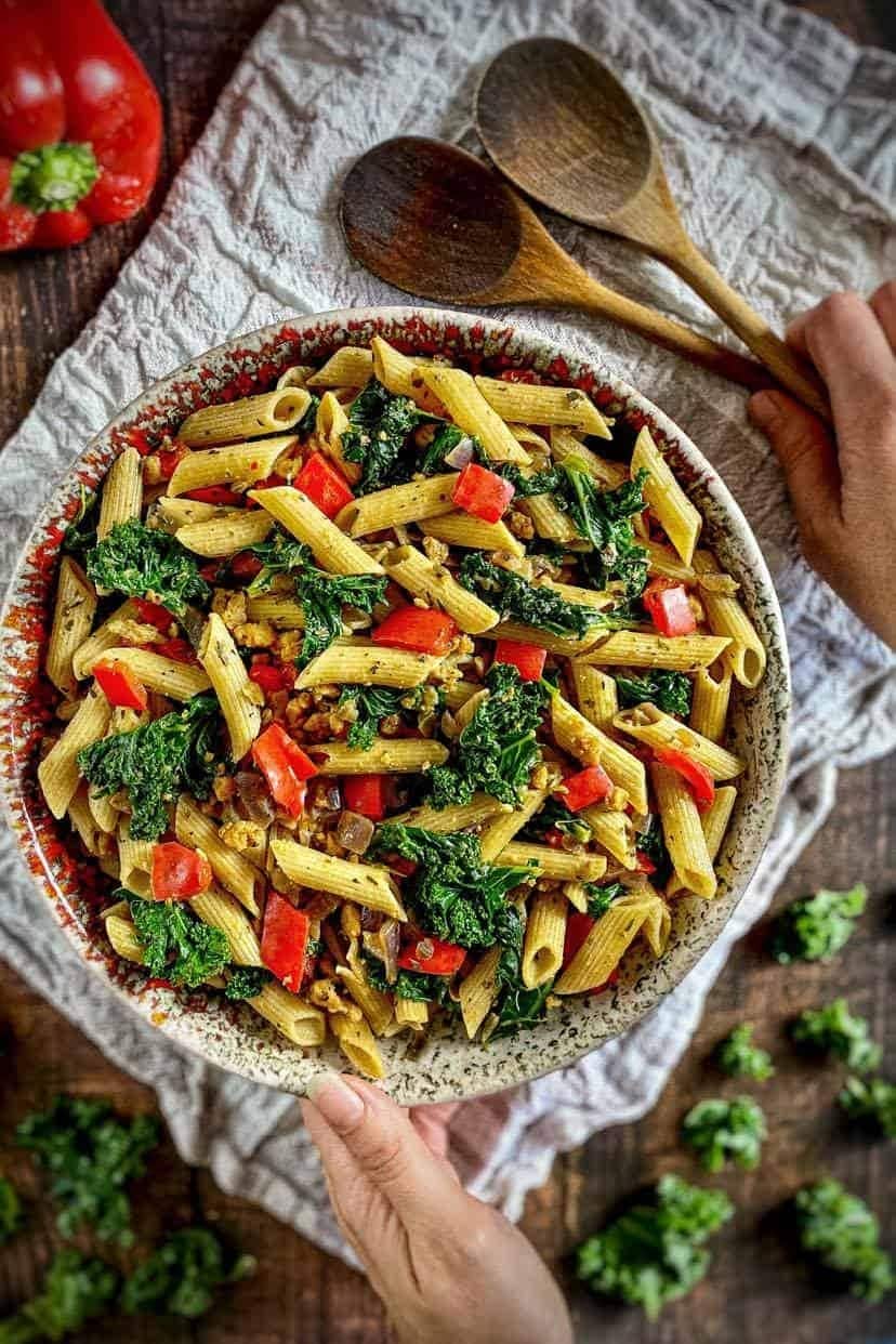 Penne pasta with kale and vegan Italian sausage on a bowl.