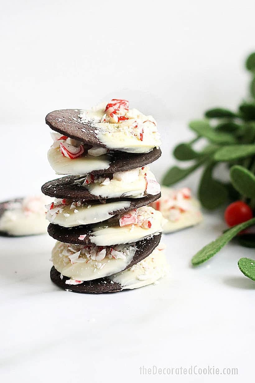 Peppermint bark cookies layered with cream frosting filling garnished with crushed candy cane candies. 