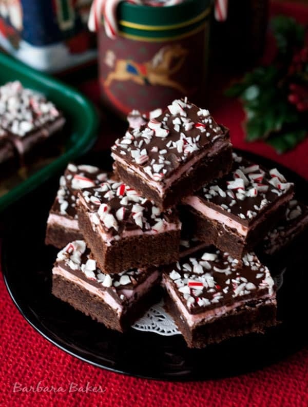 A stack of peppermint candy cane brownies garnished with crushed candies. 