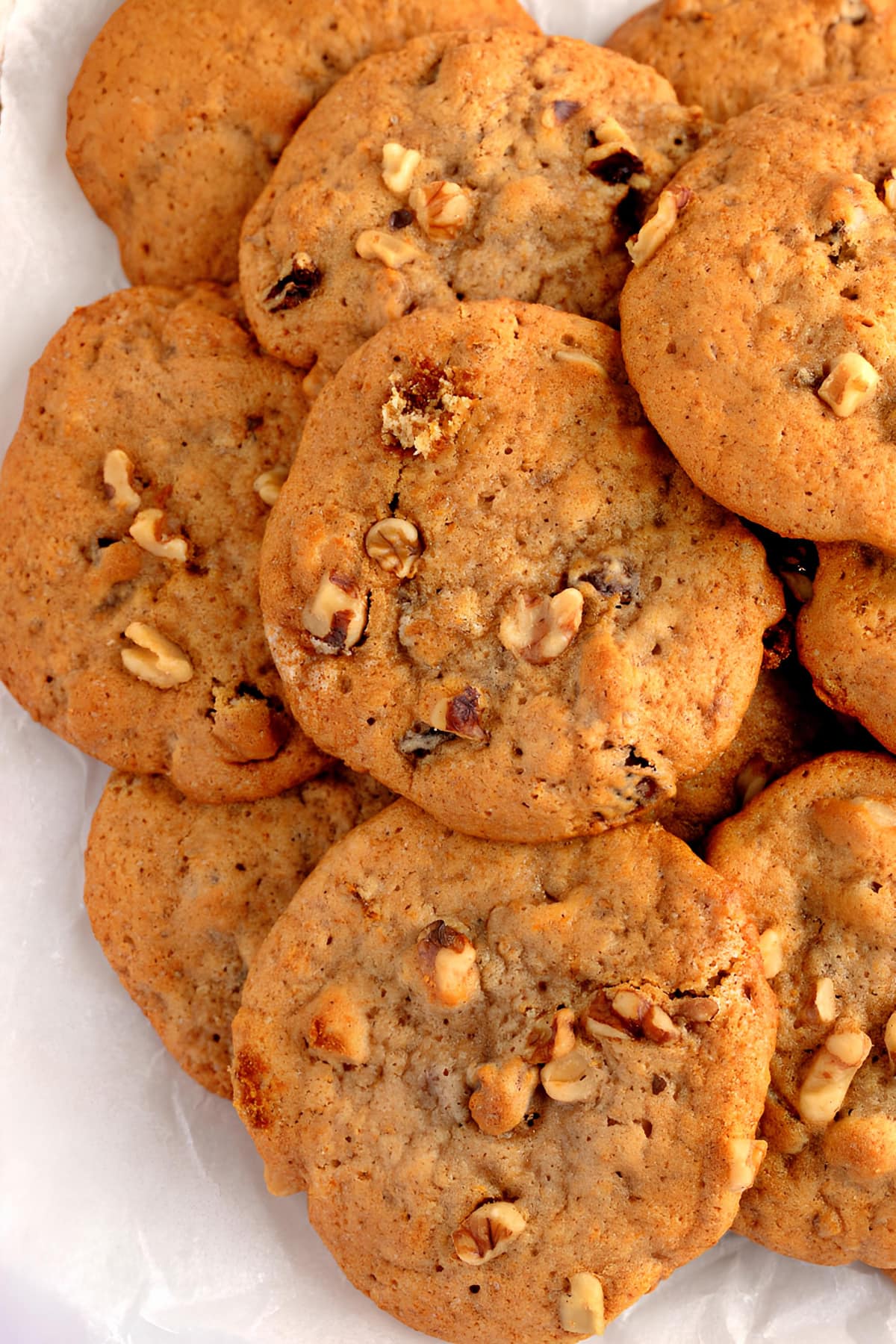 A pile of persimmon cookies with nuts close up
