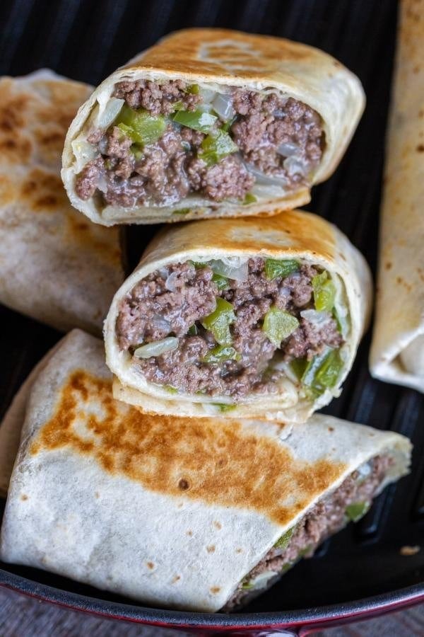 Homemade philly cheesesteak wrap with savory ground beef, peppers and cheese
