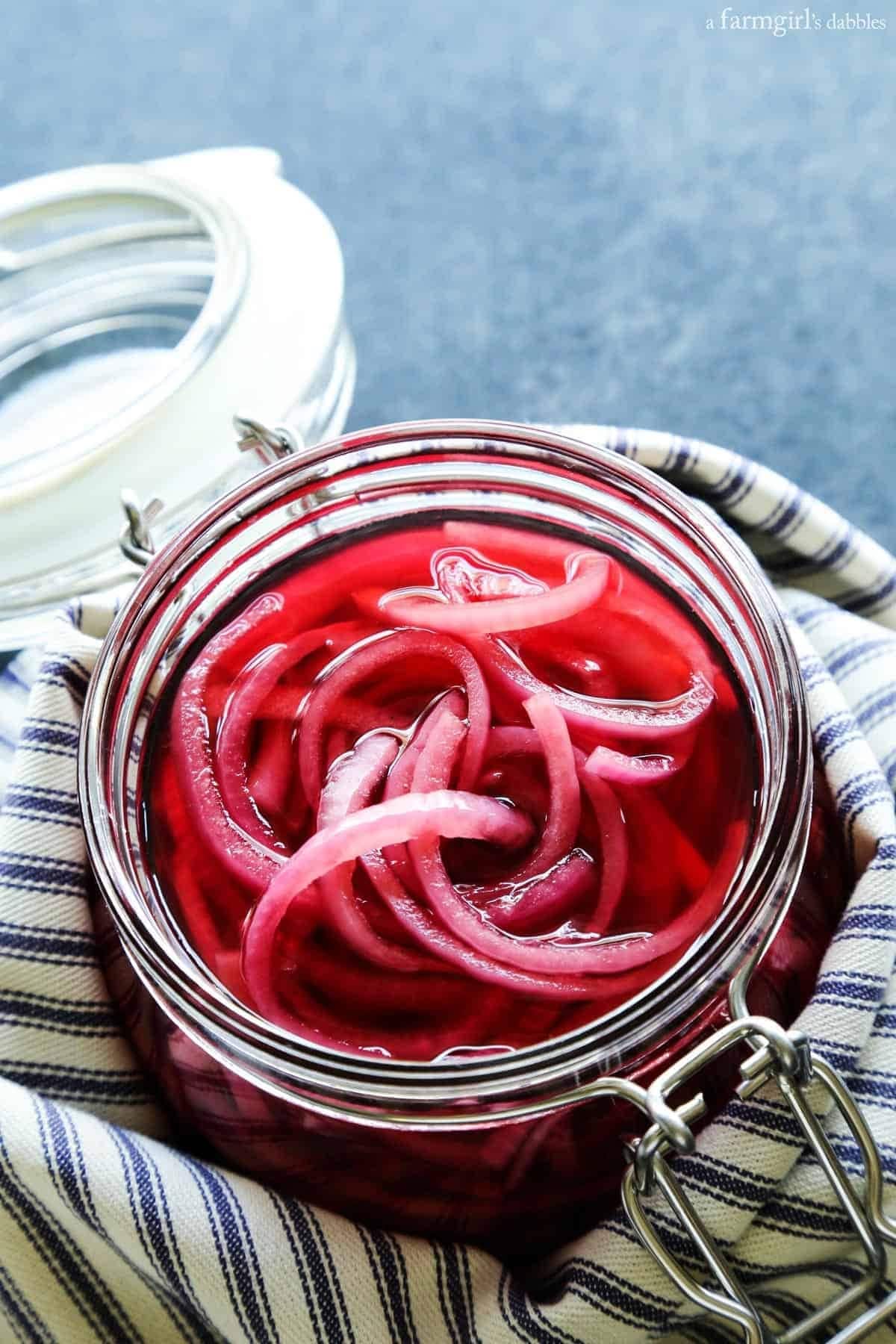 Red onions pickled on an air tight jar. 