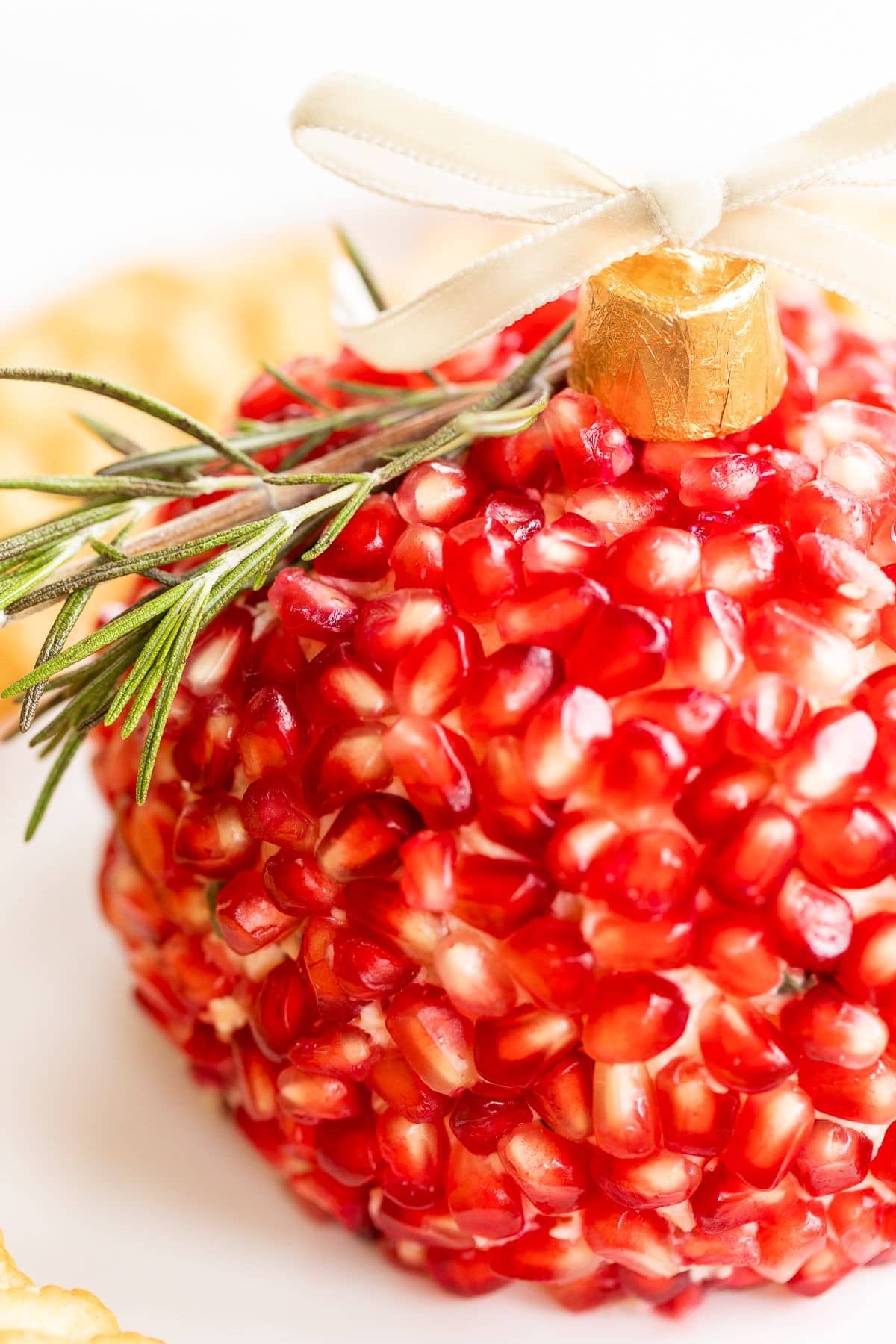 Cheeseball coated with pomegranate arils.