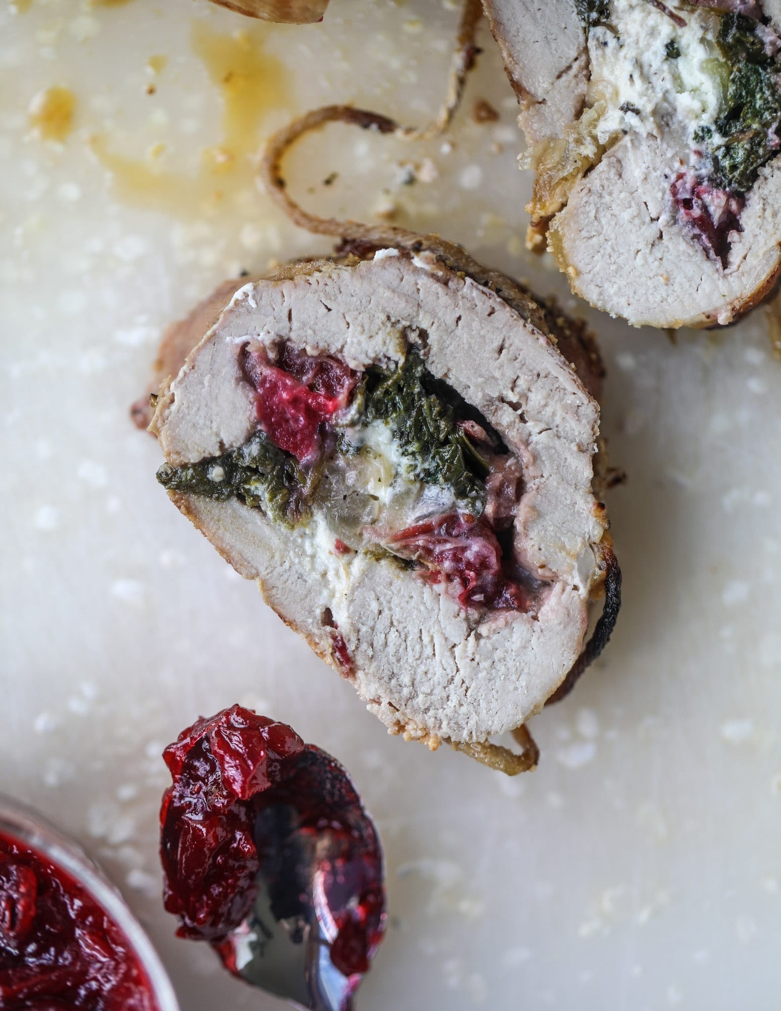 Stuffed pork tenderloin filled with caramelized onion, fresh cranberry sauce, goat cheese and fresh spinach.