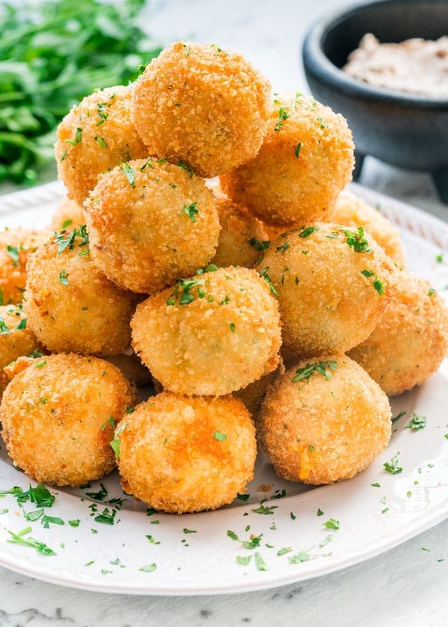 Bunch of crunchy potato croquettes on a plate.