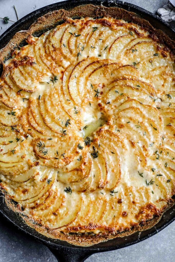 Top view of a whole serving of potatoes au gratin on a skillet.