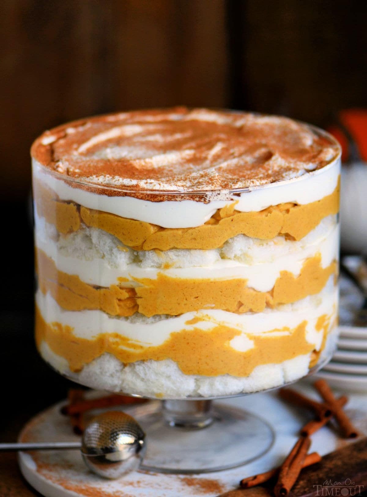 Pumpkin cheesecake trifle with layers of pumpkin cheesecake, whipped cream, and angel food cake.