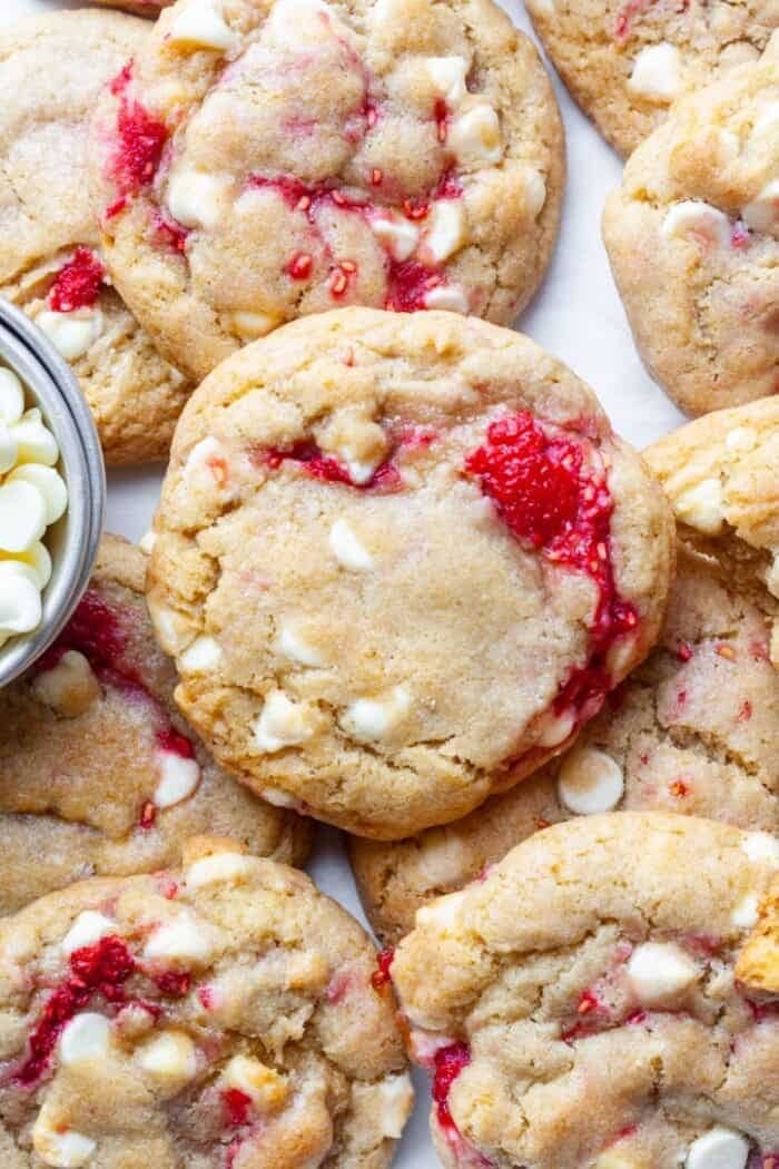 Bunch of cookies with raspberries and white chocolate.
