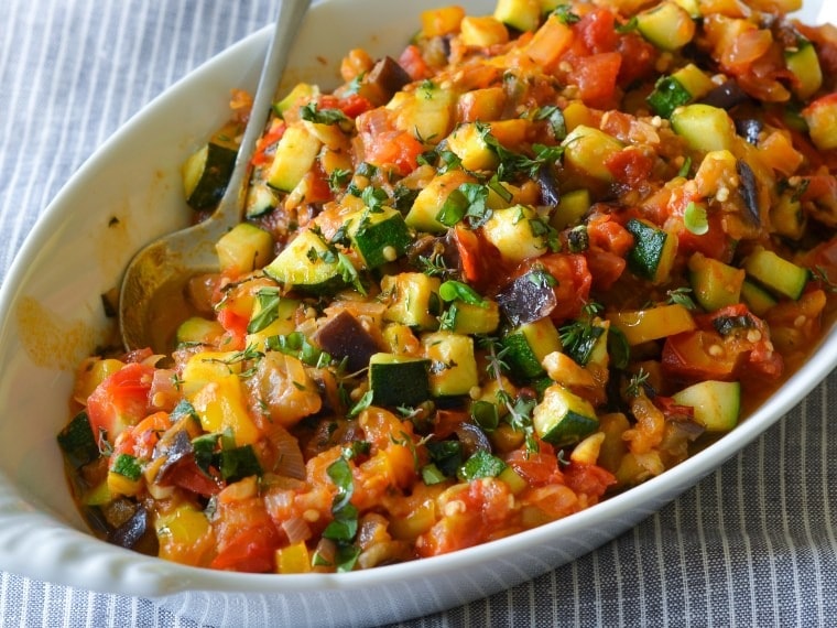 Ratatouille made with  made with eggplant, zucchini, bell peppers, and tomatoes. 