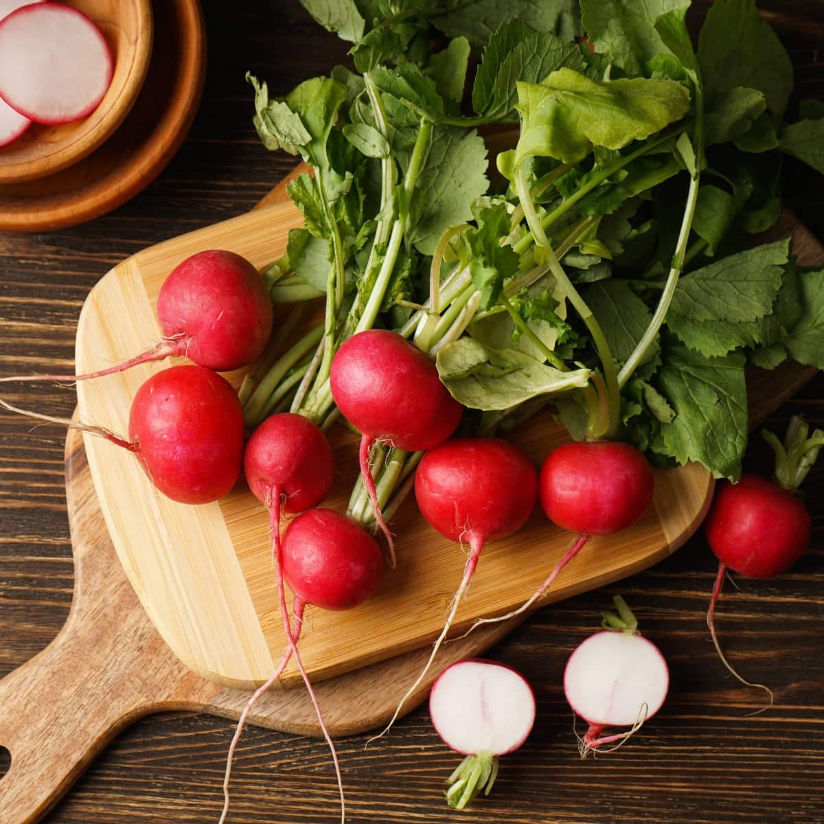 Raw Organic Red Radishes on a Wooden Board