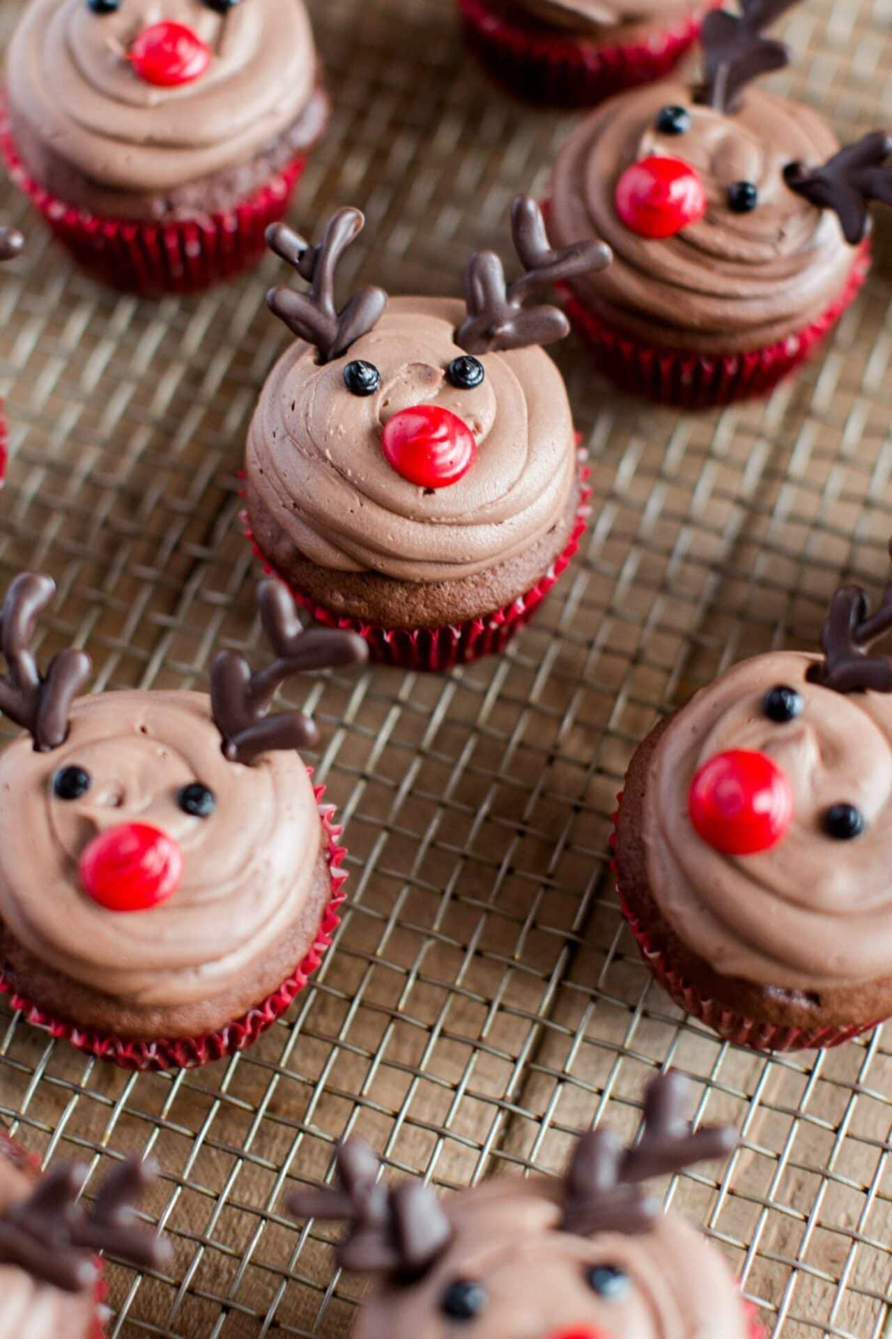 Chocolate cupcakes decorated with a reindeer face using frosting. 