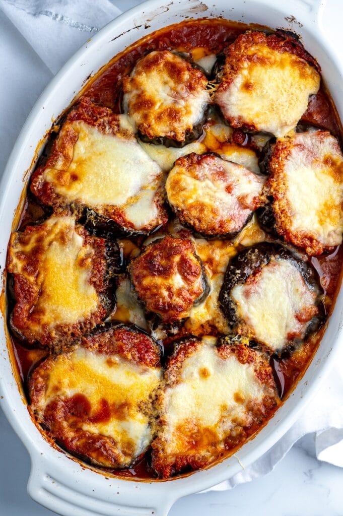 Baked eggplant with parmesan cheese on a casserole dish. 