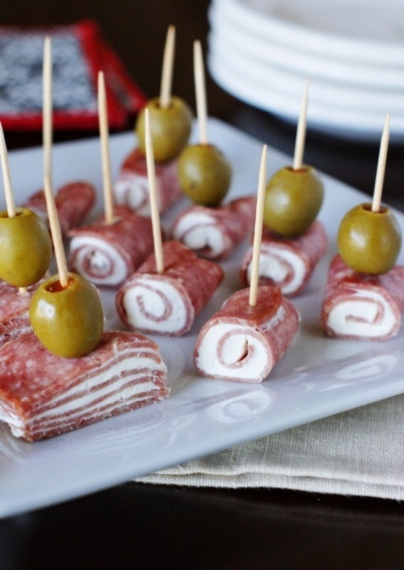 Salami, cream cheese, and olives in skewers.