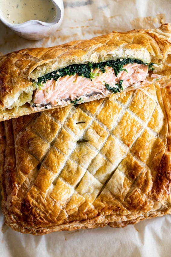 Salmon wrapped in pastry puff with spinach filling and dill sauce. 