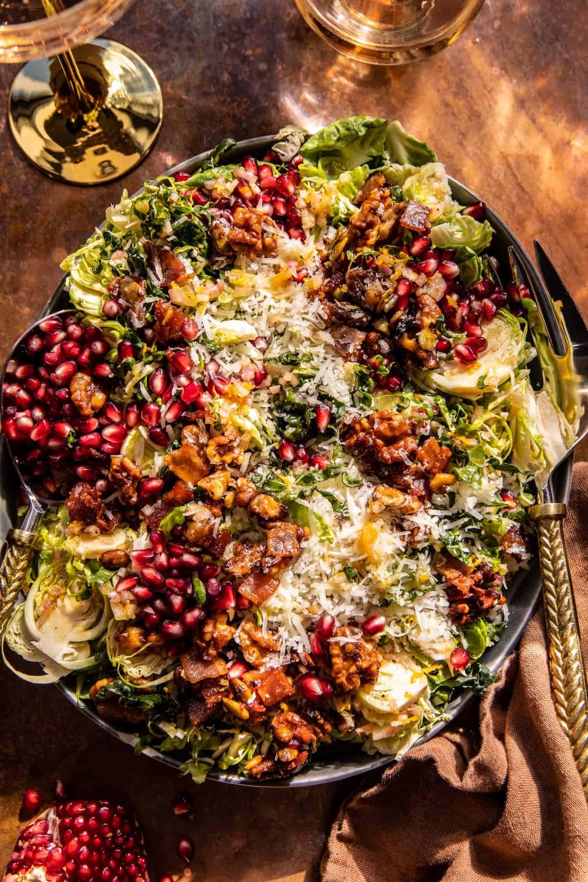 Salad with shredded brussels sprouts, kale, nutty Manchego cheese, warm candied bacon, buttered walnuts, and sweet pomegranates.
