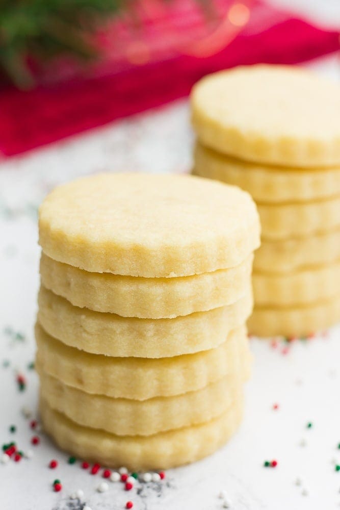 A pile of round shortbread cookies stack on each other. 