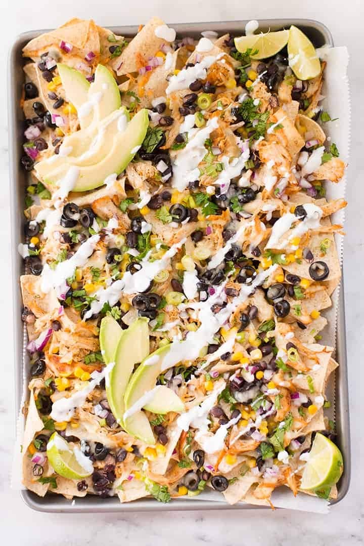 Nacho chips topped with  shredded chicken, tomatoes, black olives, salsa and avocado.