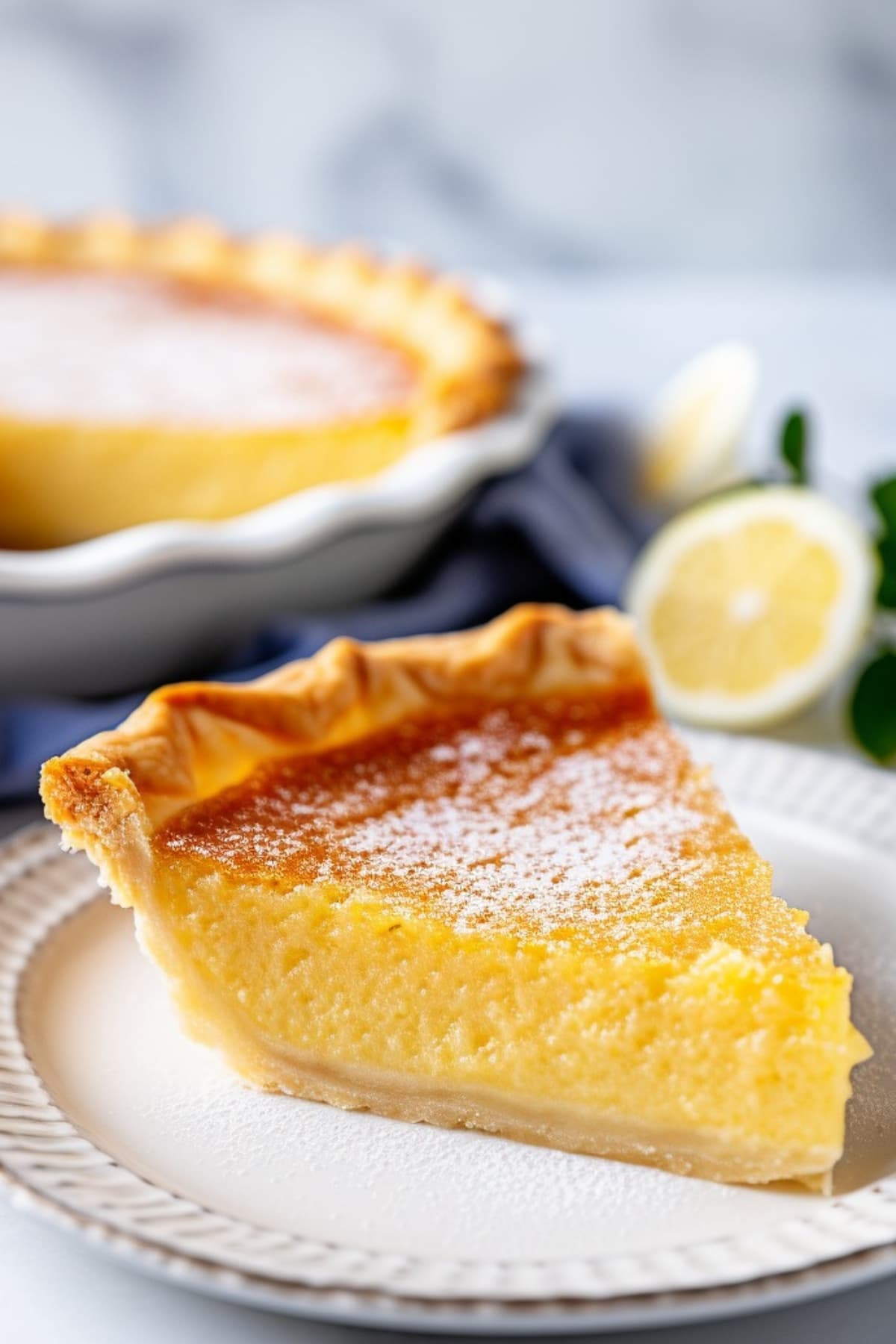 Sliced traditional buttermilk pie on a plate. 