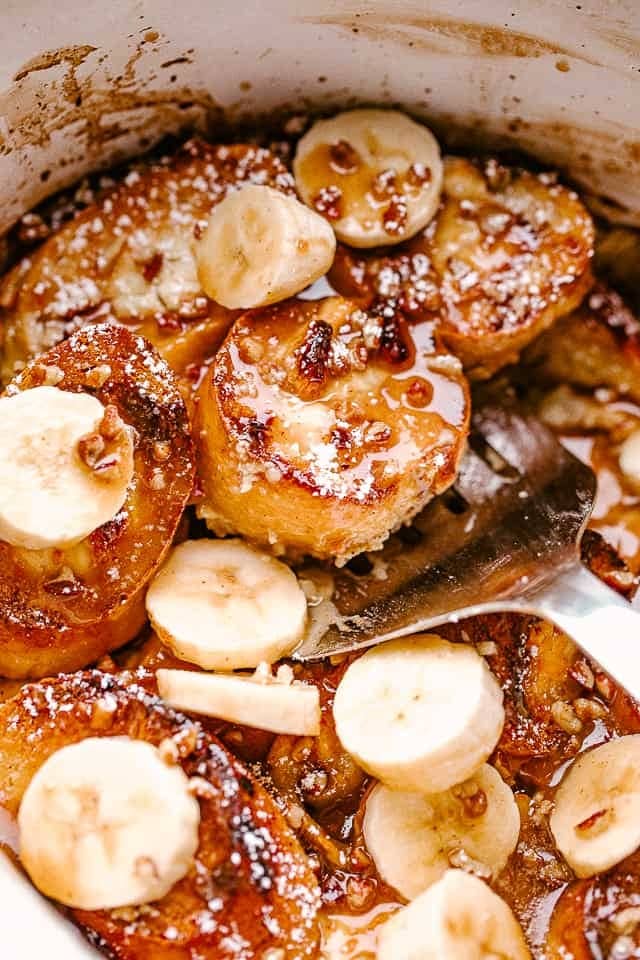 French toast cooked in a crockpot topped with sugar coated banana slices.