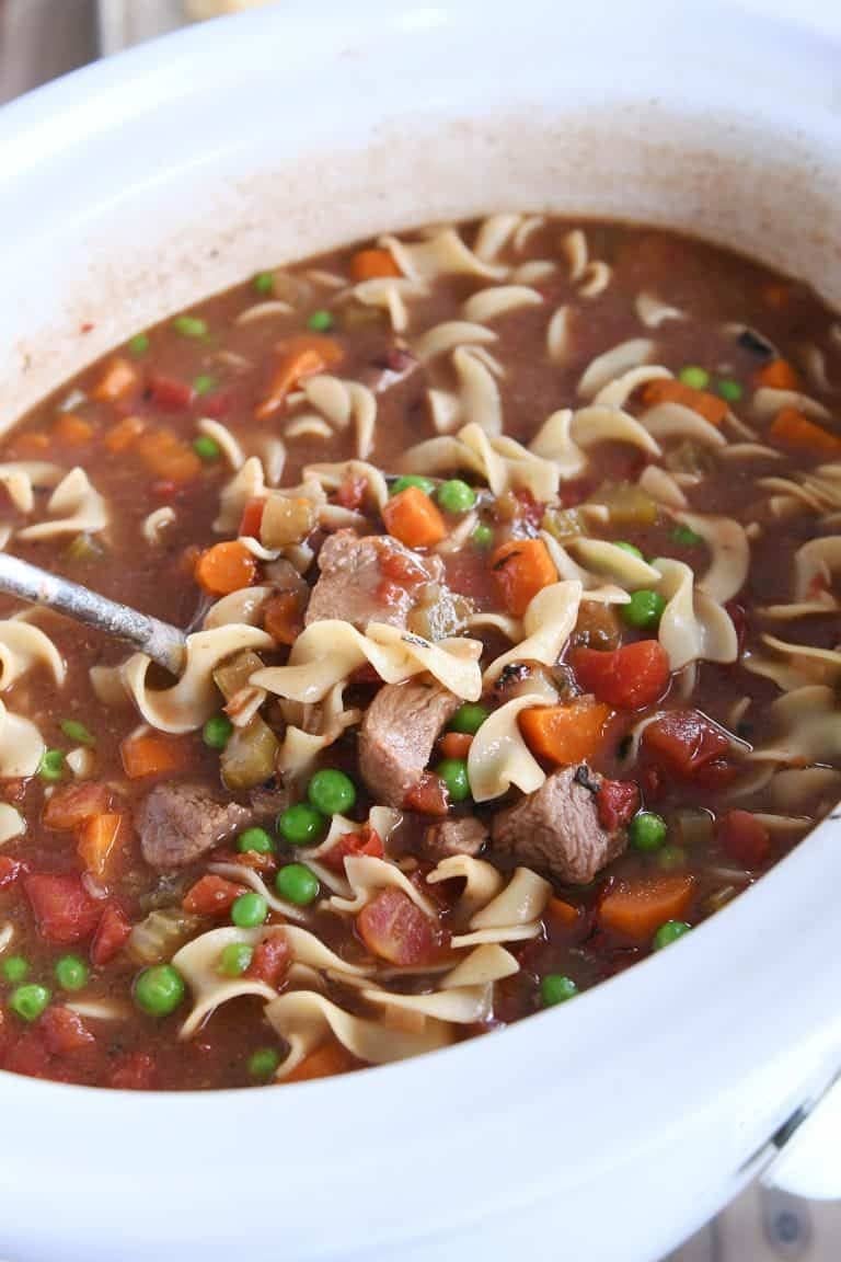 Slow Cooker Beef Noodle Soup with tomatoes, carrots and green peas
