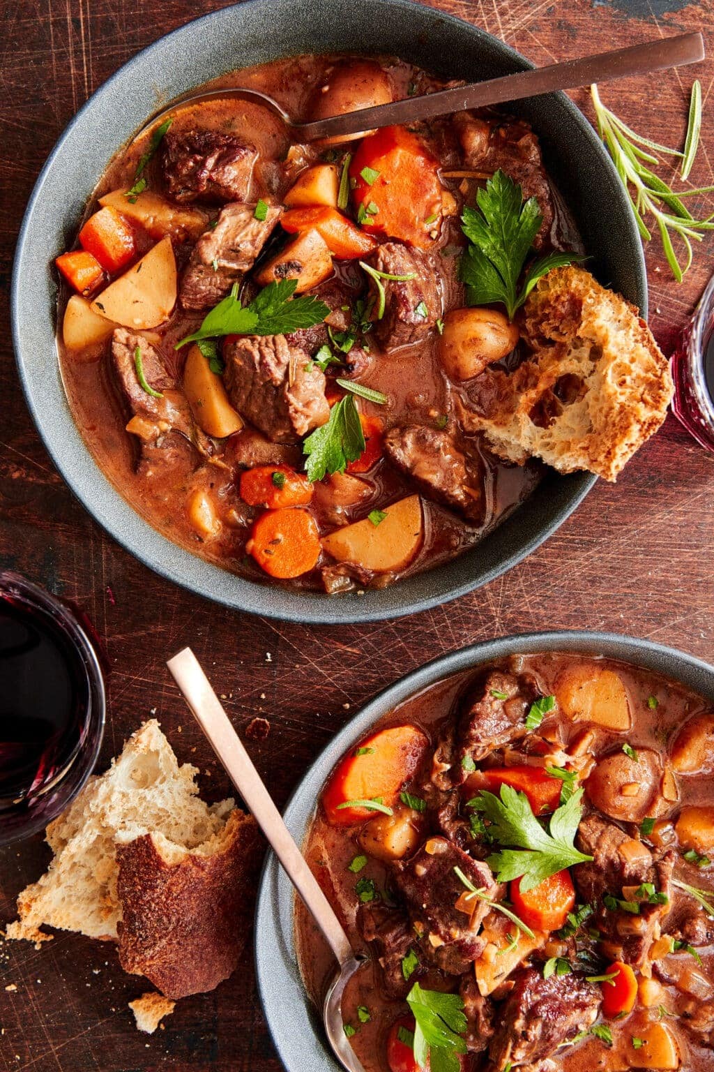 Bowls of Slow Cooker Beef Stew with carrots, potatoes and parsley 