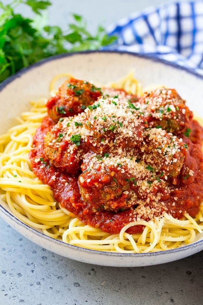 Spaghetti with Meatballs garnished with parsley and parmesan cheese