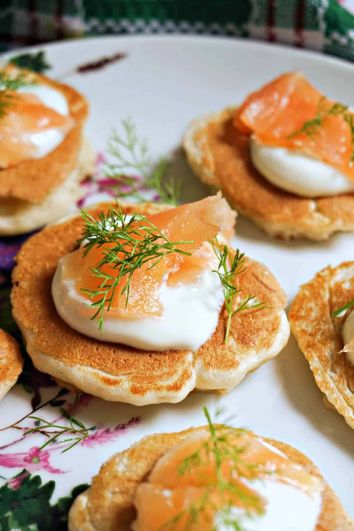 Blinis topped with silky cream, smoked salmon, dill and a touch of lemon