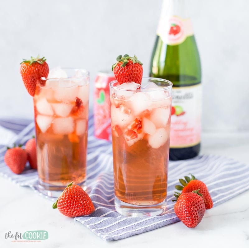 Grapefruit mocktail with ice garnished with fresh strawberries 