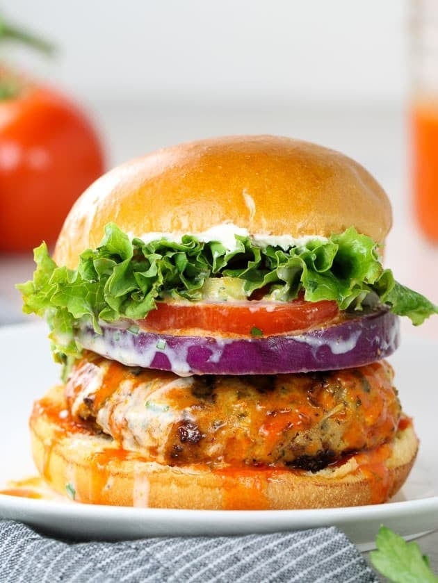 Burger with thick chicken patty, lettuce, tomatoes and cheese drizzled with buffalo wings sauce. 