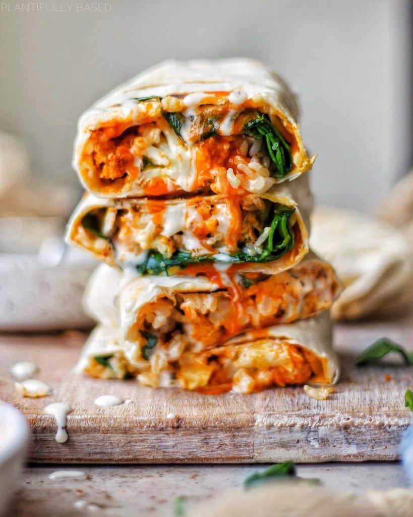 Vegan wraps with  brown rice, spinach, buffalo sauce and vegan cheese filling.