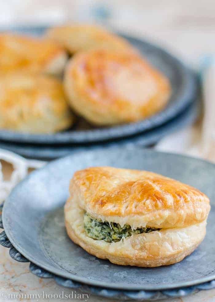 A piece of empanada with spinach and cheese filling.