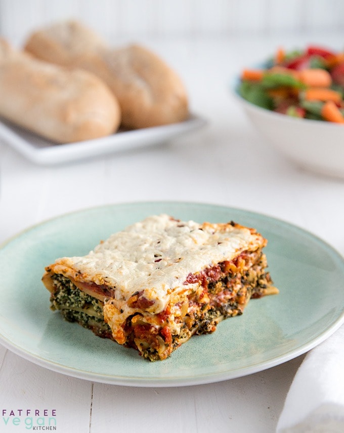 A slice of lasagna with mushroom and creamy spinach filling. 