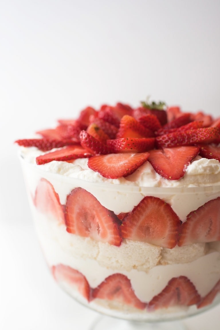 Trifle made with layers of sliced strawberries, cheesecake and angel food cake. 