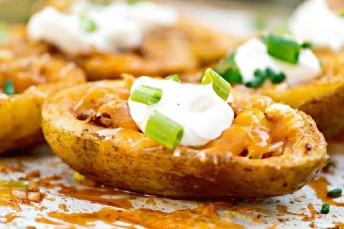 Potato skin stuffed with smoky bits of bacon, and loads of melted cheese topped with a dollop of sour cream.