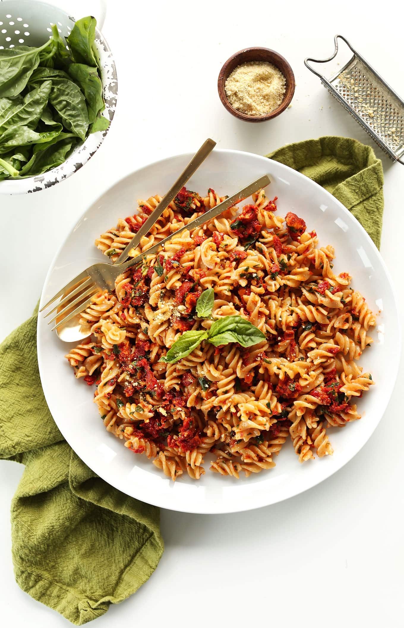 Fusilli pasta served with sun dried tomato sauce served on plate. 