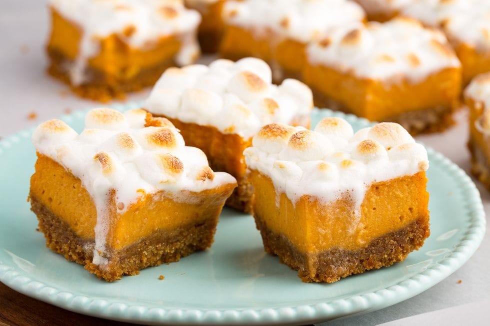 Crushed graham crackers crusted sweet potato bars topped with melted marshmallows. 