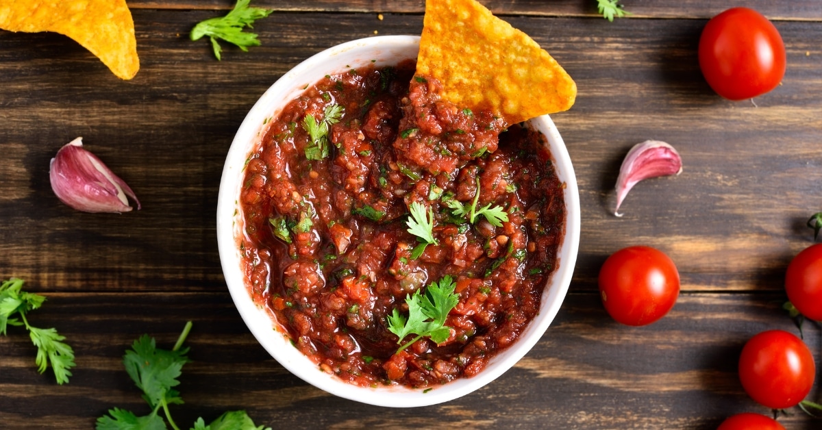 Homemade Taco Salsa Sauce in a Bowl with Cilantro, Chips and Tomatoes