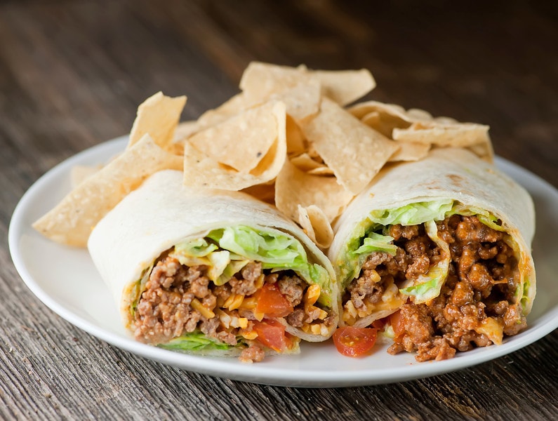Taco wraps with salsa, lettuce, onions and tomatoes