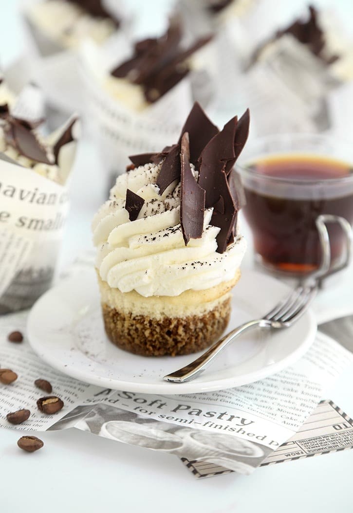 Cupcakes topped with vanilla frosting and chocolate shards.