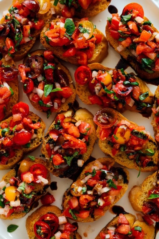 Ripe red tomatoes, earthy basil, and piquant garlic rest on top of crisp, toasted French bread