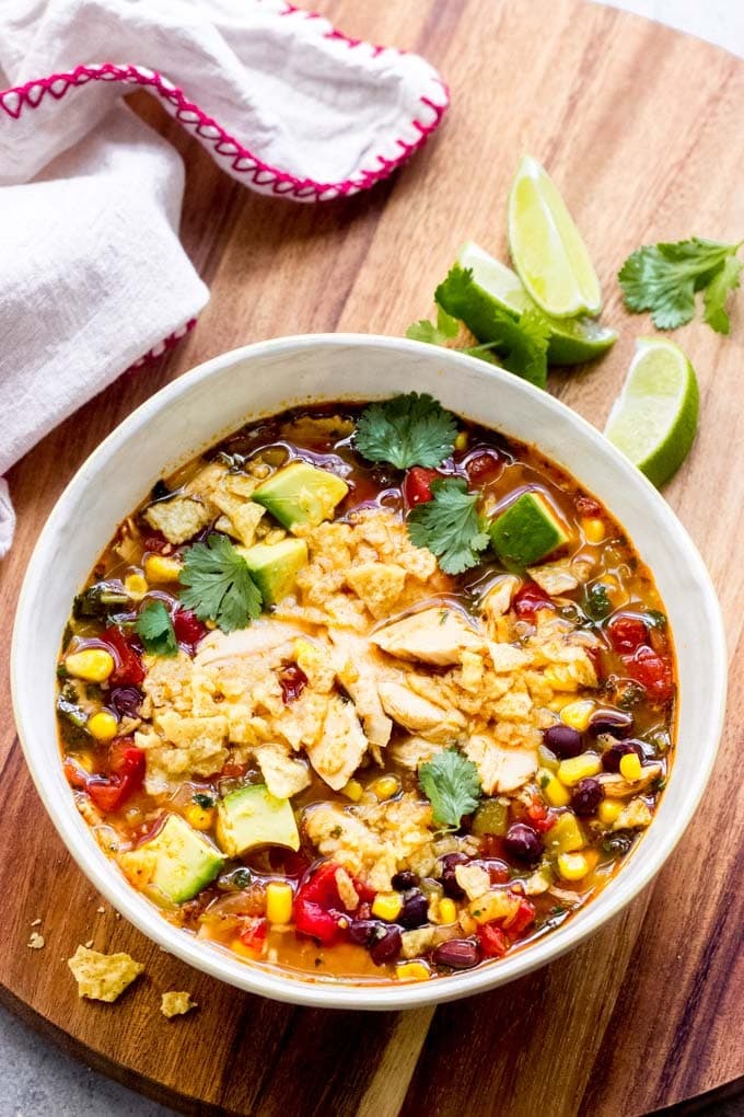 Soup on a bowl with loaded with turkey meat, tomatoes, corn, beans, and chilies.