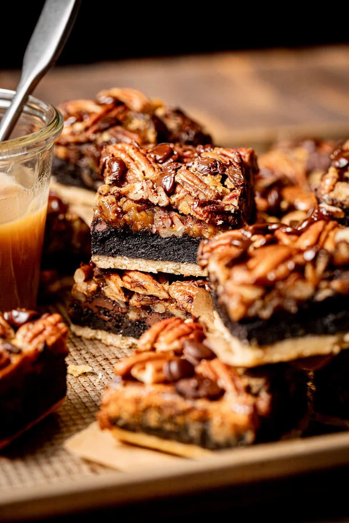 Brownies made with buttery shortbread crust, gooey brownie, and plenty of pecan on top. 