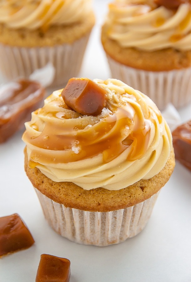 Cupcake topped with caramel frosting and bar drizzled with caramel syrup. 