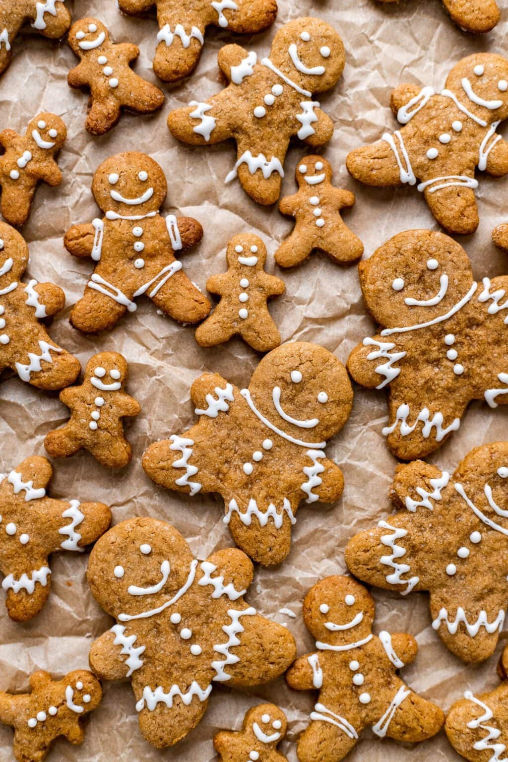 Bunch of gingerbread cookies on parchment paper.